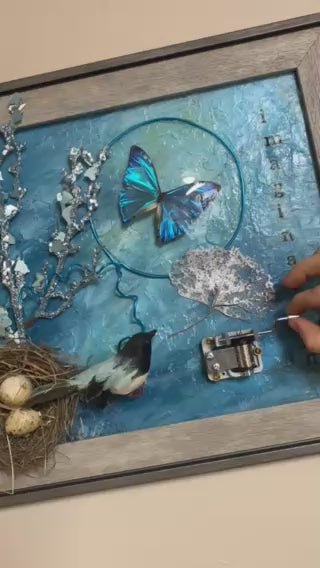 Video of the birds nest music box art with real butterflies playing music